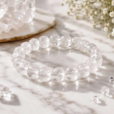 Natural Crystal Quartz (Sphatik) bracelet with 8mm clear gemstone beads on white marble, ideal for meditation, clarity and positive energy.