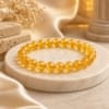 Natural Citrine Bracelet with 8mm transparent gemstone beads on luxury marble display for wealth, confidence and prosperity.