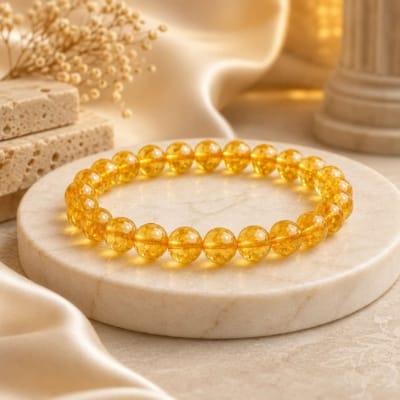 Natural Citrine Bracelet with 8mm transparent gemstone beads on luxury marble display for wealth, confidence and prosperity.