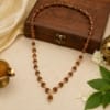 premium-rudraksha-mala-with-golden-cap-spiritual-necklace Premium Rudraksha Mala with golden caps displayed in a spiritual setting, ideal for meditation, japa, Chaalisa and daily devotion.