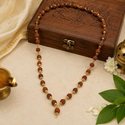 Premium Rudraksha Mala with golden caps displayed in a spiritual setting, ideal for meditation, japa, Chaalisa and daily devotion.