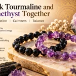 Black tourmaline and amethyst crystal bead bracelets displayed together on a marble surface with purple crystals and gold accents.